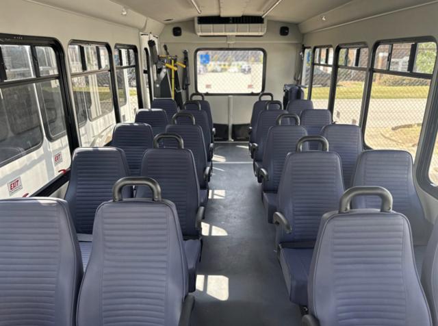 Shuttle bus interior with rear lift and flipped-up seats